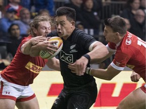 Rob Thompson of the Maori All Blacks tries to break through the defence of Dan Moor #11 and Andrew Coe #15 of Canada during an international rugby friendly match at B.C. Place on Friday, Nov. 3.