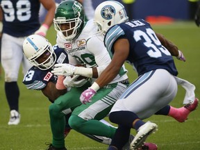 Saskatchewan Roughriders running back Kienan LaFrance is tackled by Toronto Argonauts defensive back Matt Black on Oct. 7, 2017