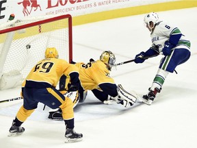 Vancouver Canucks right wing Brock Boeser scores the go-ahead goal against Nashville Predators goalie Pekka Rinne during the third period Thursday, Nov. in Nashville. The Canucks won 5-3.