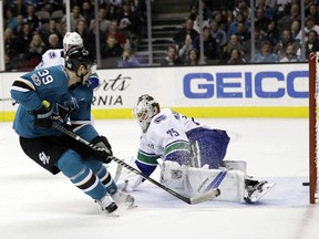 The Sharks' Logan Couture scores past Vancouver Canucks goalie Jacob Markstrom in the second period of what finished as a 5-0 blowout for San Jose.