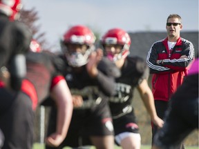 St. Thomas More Knights football head coach Steve De Lazzari watches his team practise at Byrne Creek secondary school in New Westminster on Wednesday.