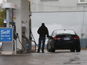 In this November 5 photo, a Torontonian fills up with some very, very expensive fuel.