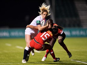 BARNET, ENGLAND - NOVEMBER 17: Abigail Dow of England is tacked by Anais Holly of Canada during the Old Mutual Wealth Series between England Women and Canada Women at Allianz Park on November 17, 2017 in Barnet, England.