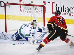 Jacob Markstrom was excellent for the Canucks in the second of back-to-back starts in net, here
deflecting a shot over the net in front of the Flames' Michael Stone. Vancouver beat Calgary 5-3 to start their road trip.