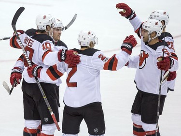New Jersey Devils' Jimmy Hayes, from left, Blake Coleman, John Moore, Taylor Hall and Damon Severson celebrate Hayes's goal against the Vancouver Canucks during the second period.