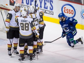 Brayden McNabb, Nate Schmidt, Erik Haula, David Perron, James Neal celebrate Haula's goal as Vancouver Canucks' Sam Gagner kneels on the ice during the third period. The Canucks were trampled in the final frame for a 5-2 home loss.