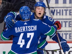 Brock Boeser of the Vancouver Canucks celebrates his goal against the Vegas Golden Knights on Thursday with teammate Sven Baertschi at Rogers Arena in Vancouver.
