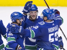 Sven Baertschi, Brock Boeser, Bo Horvat

Vancouver Canucks' Sven Baertschi, left, of Switzerland, Brock Boeser, centre, and Bo Horvat celebrate Boeser's second goal against the Pittsburgh Penguins during the second period of an NHL hockey game in Vancouver, B.C., on Saturday November 4, 2017. THE CANADIAN PRESS/Darryl Dyck ORG XMIT: VCRD120
DARRYL DYCK,