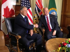 Washington State Gov. Jay Inslee meets Premier John Horgan in the premier's B.C. legislature office on Nov. 21, 2017, before Inslee addresses the legislature.