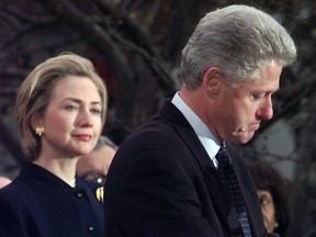 Hillary Rodham Clinton watches President Clinton pause as he thanks those Democratic members of the House of Representatives who voted against impeachment in this Dec. 19, 1998 file photo.