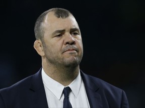 FILE - In this Saturday, Oct. 8, 2016 file photo, Australia's head coach Michael Cheika watches his team warm up prior to The Rugby Championship game between Argentina and Australia at Twickenham stadium in London. If it was hard to take your eyes off the England-Australia rugby test at Twickenham Saturday, Nov. 18, 2017, the same could be said about Wallabies coach Michael Cheika's all-action performance up in the stands. He raged, he swore, he sarcastically applauded the match officials, he even became entangled in a verbal spat with an England fan. Australia lost 30-6, a record margin of defeat against England. (AP Photo/Alastair Grant, File)