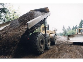 Dump truck works on the Island Highway project near near Courtenay in May 2001. The Vancouver Board of Trade in 1994 estimated the unionized project labour agreements increased the construction cost of the highway by 38 per cent.