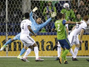Sounders star Clint Dempsey (2) watches as Whitecaps goalkeeper Stefan Marinovic can't reach his second-half goal in the MLS Western Conference semifinal at CenturyLink Field in Seattle Thursday night. Dempsey would add an insurance marker in a convincing 2-0 aggregate win over Vancouver.
