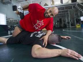 Arjan Bhullar of Richmond, top, seen here sparring with friend Brad Hildebrandt, wrestled for Canada at the 2010 Commonwealth and Pan-American Games. Bhullar is now a coach of the University of the Fraser Valley wrestling team.