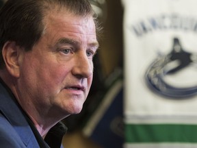 Vancouver Canucks general manager Jim Benning speaks with reporters in Penticton during the team's 2017 training camp.