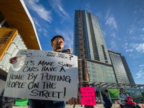 Community members, including Jason Bang, protest in front of Surrey City Hall in Surrey on Sunday, Nov. 5, 2017.