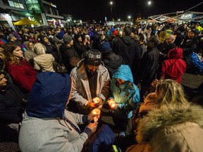 People attend a vigil for Const. John Davidson at Mount Lehman Centre mall in Abbotsford, B.C., November 13, 2017. The candlelight vigil was open to the public, to honour police Const. John Davidson, killed Nov. 6 while on duty in Abbotsford.