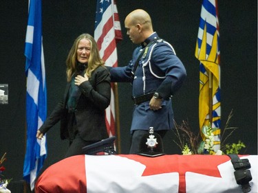 Denise, the wife of Const. John Davidson walks by her husband's casket  during his funeral Sunday in Abbotsford.