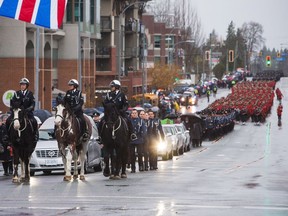 The funeral procession carrying the body of Abbotsford Police Const. John Davidson, who was killed in the line of duty on Nov. 6, makes its way to a memorial in Abbotsford on Sunday.