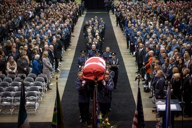 Pallbearers carry the casket of Abbotsford Police Const. John Davidson, who was killed in the line of duty Nov. 6, into a memorial service in Abbotsford on Sunday, Nov. 19, 2017.