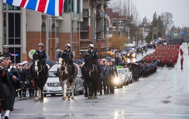 The funeral procession carrying the body of Abbotsford Police Const. John Davidson, who was killed in the line of duty Nov. 6, makes its way to a memorial service in Abbotsford, on Sunday, Nov. 19, 2017.