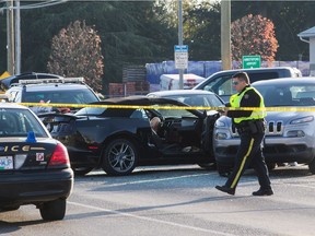 Police officers investigate the scene of a shooting that left one Abbostford Police officer dead in Abbotsford, B.C., on Monday November 6, 2017.