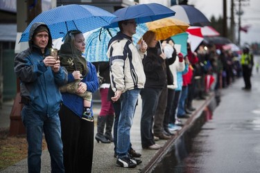 Crowds line the street for a final goodbye as a hearse carrying the body of Abbotsford Police Const. John Davidson makes its way through the streets of Abbotsford on Sunday, Nov. 19, 2017. Davidson was shot and killed in the line of duty on Nov. 6.