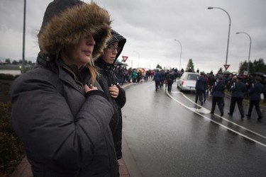 Crowds line the street for a final goodbye as a hearse carrying the body of Abbotsford Police Const. John Davidson makes its way through the streets of Abbotsford on Sunday, Nov. 19, 2017. Davidson was shot and killed in the line of duty on Nov. 6.