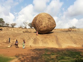 “Krishna’s butterball,” a gigantic boulder sitting on the hilltop that, according to scientists, defies the laws of physics is found at Mamallapuram’s heritage site of temples and monuments.