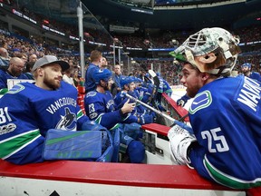 Jacob Markstrom of the Vancouver Canucks talks to teammate Anders Nilsson during their NHL game against the Ottawa Senators at Rogers Arena in October.