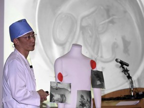 FILE - in this Nov. 15, 2017, photo, medical doctor Lee Cook-jong describes the parasites found inside the body of a North Korean soldier at Ajou University Medical Center in Suwon, South Korea. Hospital officials say on Saturday, Nov. 18, 2017, the condition of the North Korean soldier severely wounded by gunfire while escaping to South Korea is gradually improving after two surgeries but it's too early to tell whether he makes a recovery.(Kim In-chul/Yonhap via AP, File)
