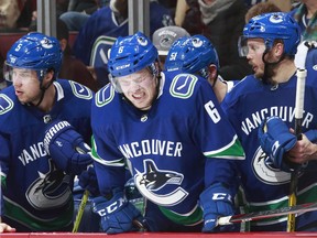 Brock Boeser, looking unhappy after blocking a shot Sunday against the Flames.