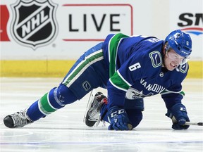 Brock Boeser of the Vancouver Canucks crawls across the ice to the bench after blocking a shot during their NHL game against the Calgary Flames at Rogers Arena on Sunday.