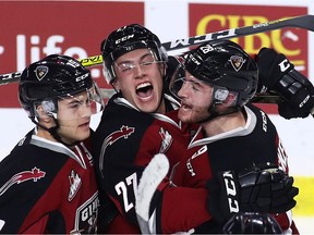 Brendan Semchuk #27 of the Vancouver Giants celebrates his goal against the Victoria Royals with teammates Dawson Holt #19 (L) and Darian Skeoch #28 during the second period of their WHL game at the Langley Events Centre on October 5, 2016 in Langley, British Columbia, Canada.