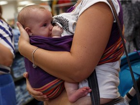 A mother breast feeds her daughter in Madrid, Spain, in 2013.