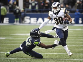 Running back Todd Gurley of the Los Angeles Rams is tackled by linebacker Terence Garvin of the Seattle Seahawks during the 2nd quarter of the game at CenturyLink Field on December 17, 2017 in Seattle, Washington.