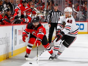 Kyle Palmieri of the New Jersey Devils, left, battles for puck possession with Chicago Blackhawks' defenceman Gustav Forsling on Dec. 23 at the Prudential Center in Newark, N.J. Forsling may end up being one of the big Canucks who got away.