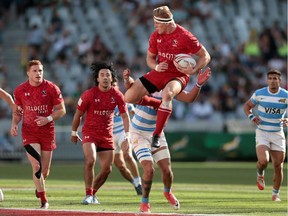 Canada's John Moonlight  jumps for the ball during the semi-final against Argentina at the Cape Town 7s.