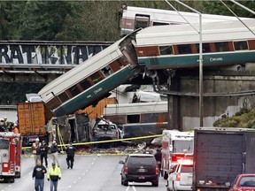 Cars from an Amtrak train lay spilled onto Interstate 5 below alongside smashed vehicles as some train cars remain on the tracks above Monday, Dec. 18, 2017, in DuPont, Wash. The Amtrak train making the first-ever run along a faster new route hurtled off the overpass Monday near Tacoma and spilled some of its cars onto the highway below, killing some people, authorities said. Seventy-eight passengers and five crew members were aboard when the train moving at more than 80 mph derailed about 40 miles south of Seattle before 8 a.m., Amtrak said.