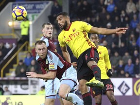 Scott Arfield of Burnley, left, and Watford's Adrian Mariappa battle for the ball during English Premier League action earlier this month at Turf Moor in Burnley, England.