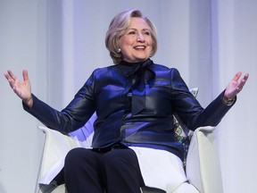 Sporting a boot on her right foot due to a broken toe, Hillary Clinton speaks during a book tour event in Vancouver, B.C., on Wednesday December 13, 2017.