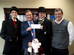 From left, Kyle Murray (dressed as Bob Cratchit), Bruce Rosberg, Wayne Kuyer (dressed as Jacob Marley) and Lee Sawatzky raise money for The Province's Empty Stocking Fund Thursday at the Rosberg Sawatzky law offices in Langley.