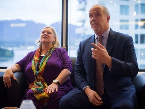 John Horgan and his wife Ellie watch election results on television at a Vancouver hotel on May 9. Horgan says he faced opposition in his family over his controversial Site C decision. Ellie was opposed to the project, as was his brother Pat, who has terminal cancer.