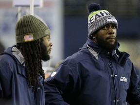 Injured Seattle Seahawks cornerback Richard Sherman, left, and strong safety Kam Chancellor have been sharing a lot of their insight into their positions with the players who stepped in to replace them.
