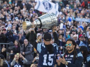 Toronto Argonauts' Ricky Ray holds the Grey Cup as fans gathered in Toronto's Nathan Phillips Square as the team holds a Cup winning rally, on Tuesday , November 28 2017.