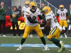 Edmonton Eskimos QB James Franklin (left) hands the ball off to RB LaDarius Perkins during pre-season action. (Kevin King/Postmedia Network)