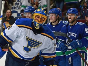 VANCOUVER, BC - DECEMBER 23: Jake Allen #34 of the St. Louis Blues looks on dejected as teammates congratulate Brock Boeser #6 of the Vancouver Canucks after his 20th goal during their NHL game at Rogers Arena December 23, 2017 in Vancouver, British Columbia, Canada.  (Photo by Jeff Vinnick/NHLI via Getty Images) ORG XMIT: 775041088 [PNG Merlin Archive]

Not Released