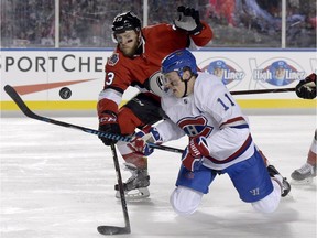 Montreal Canadiens' right-winger Brendan Gallagher battles for puck possession with Ottawa Senators' defenceman Fredrik Claesson during the NHL 100 Classic in Ottawa on Saturday, Dec. 16.