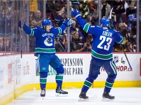 Vancouver Canucks' Markus Granlund, left, and Alexander Edler celebrate Granlund's goal against the Toronto Maple Leafs during the first period of Saturday's game in Vancouver.