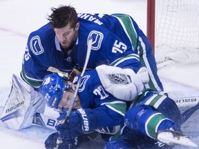 Daniel Sedin crashes into  Jacob Markstrom during third period NHL action against the Flyers Thursday.